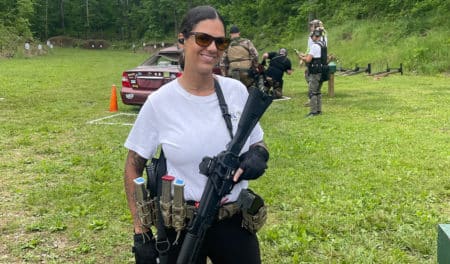 Alaina Hicks at Kalashni-Con 2022 holding a Kalashnikov USA KR-103.