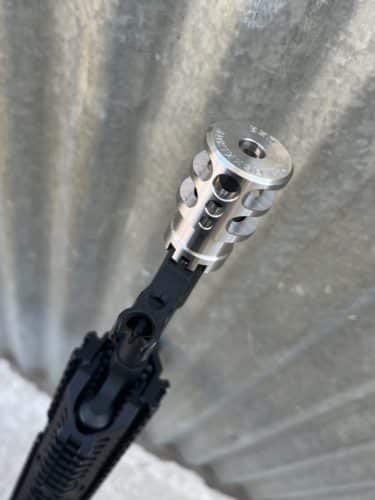Close of of Jesse James Firearms Unlimited Dragon Brake Muzzle attached on Kalashnikov USA rifle.